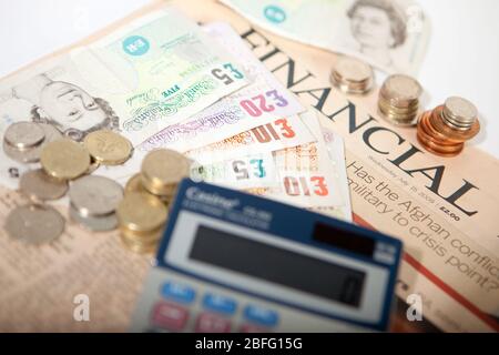 Illustrative image of various denomination sterling pound notes and coins. Stock Photo