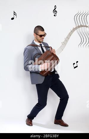 Portrait of successful and confident music lover guy having fun. Happiness, success, business concept. Stock Photo