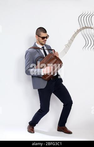 Portrait of successful and confident music lover guy having fun. Happiness, success, business concept. Stock Photo