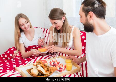 Family having breakfast in bed Stock Photo