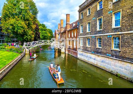 People punting on the River Cam under the Mathematical Bridge, Cambridge, UK