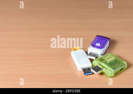 Close-up of  usb flash drive  and     sd card adapter  on wooden background . Stock Photo