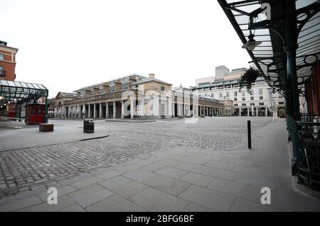 London, UK. 18th Apr, 2020. Day Twenty Six of Lockdown in London. Midday and Covent Garden Market is deserted on a very quiet central London for a Saturday as the country is on lockdown due to the COVID-19 Coronavirus pandemic. People are not allowed to leave home except for minimal food shopping, medical treatment, exercise - once a day, and essential work. COVID-19 Coronavirus lockdown, London, UK, on April 18, 2020 Credit: Paul Marriott/Alamy Live News Stock Photo