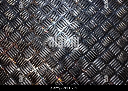Background made of silver and black non-slip metal surface, visible light reflection, top view. Stock Photo
