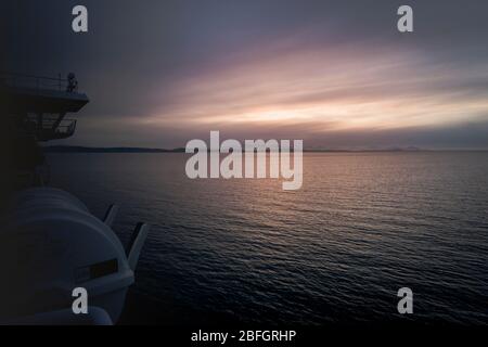 Colorful sunset over peaceful Pacific Ocean from Ferry on the route from Vancouver to Victoria Stock Photo