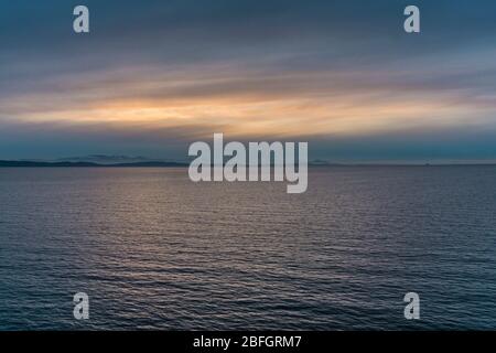 Colorful sunset over peaceful Pacific Ocean from Ferry on the route from Vancouver to Victoria Stock Photo