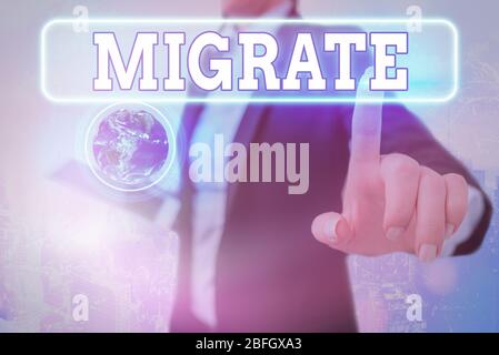 Writing note showing Migrate. Business concept for to move or travel from one country place or locality to another Elements of this image furnished by Stock Photo