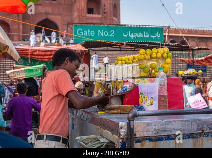 Delhi/ India - October 11,2019. An Unidentified Boy selling Nimbu Paani/ Lemon water  at Meena Bazar. in Front of Jama Masjid . Stock Photo