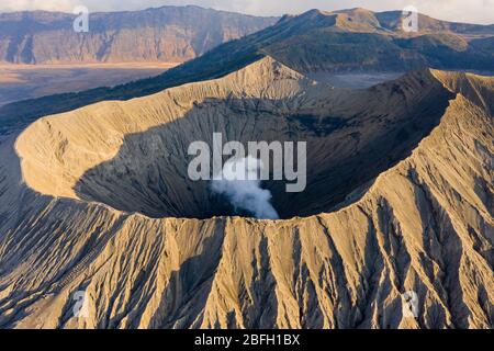 Aerial drone view of steam and volcanic gas venting from the crater of an active volcano (Mount Bromo, Java,Indonesia)