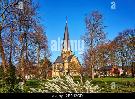 Spring flowers in front of the St. Petri church in Thale. Saxony-Anhalt, Harz, Germany Stock Photo