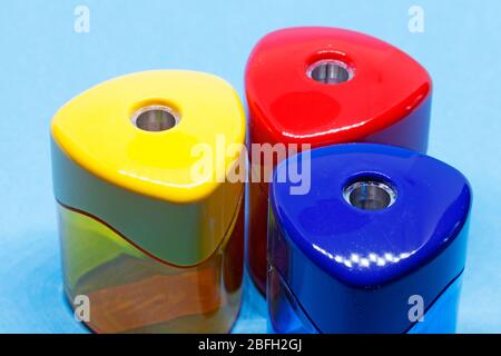 one red, one yellow and one blue pen sharpener in plastic Stock Photo