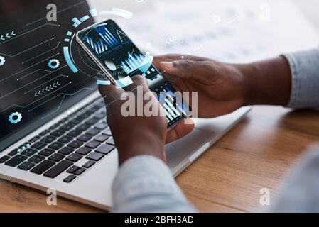 Businessman using smart phone with holograms datas Stock Photo