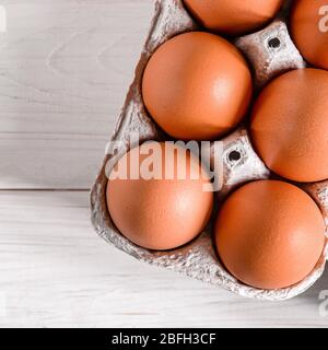 Large brown chicken eggs lie in an eco-friendly cardboard egg tray Stock Photo