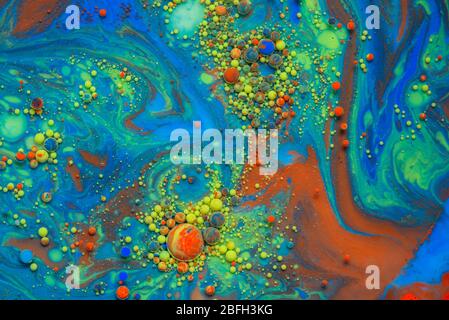 Colorful artistic background with various colors mixed with oil and milk Stock Photo