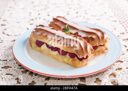 Eclairs with raspberries. delicious dessert Stock Photo