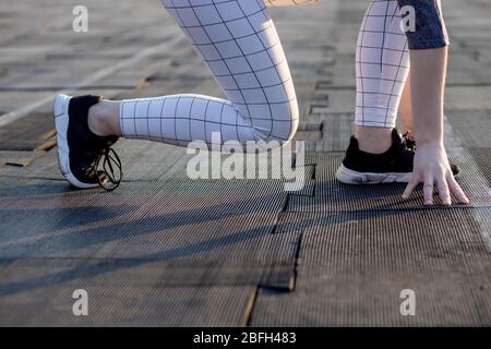 Female sprinter waiting for the start on an airport runway Stock Photo
