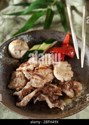 pork meat slices fried in garlic sauce with vegetables Stock Photo