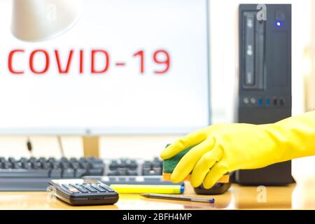 Disinfecting of an office with spray and glove to prevent COVID-19 disease Stock Photo