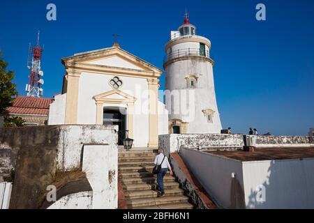 Man walking up the stair at the Guia Fortress, a 17th-century colonial military fort, chapel and lighthouse complex in Macau, China. Stock Photo