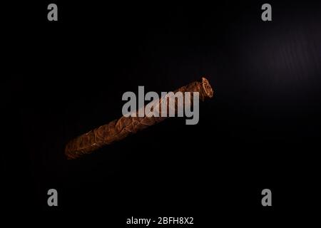 A Cuban cigar on a black background Stock Photo