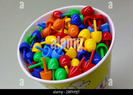 Small colored toys in a bucket of popcorn Stock Photo