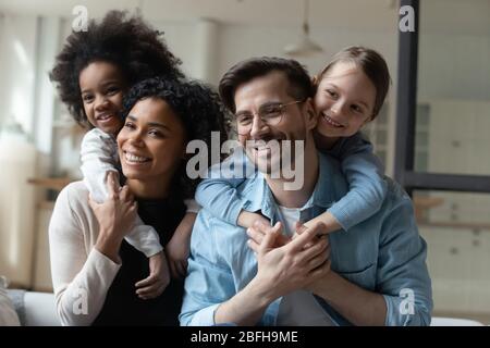 Excited little girl play with loving parents at home Stock Photo