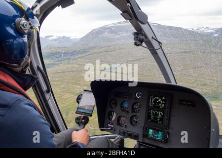 Pilot in the interior of an helicopter during a flight Stock Photo