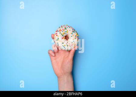 Photo of woman person hand holding rising up delicious nice beautiful single white with colorful sprinkles isolated over bright background with copy e Stock Photo
