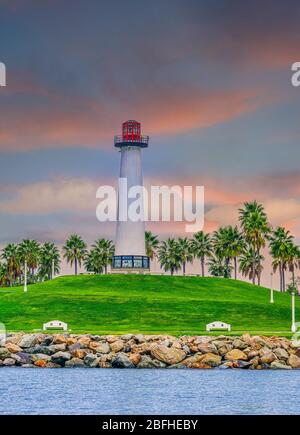 Lighthouse on Green Hill at Dusk Stock Photo
