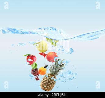 Fresh fruits dropped into water Stock Photo
