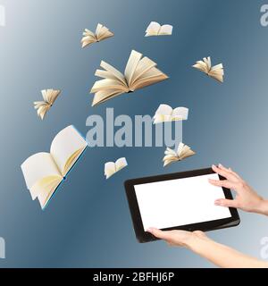 Tablet and opened books on blue background Stock Photo