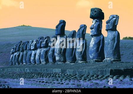 Pop art style blue and orange colored gigantic Moai statues of Ahu Tongariki on Easter Island of Chile, South America Stock Photo
