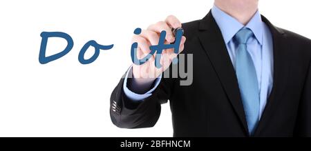 Businessman writing Do it on transparent board Stock Photo