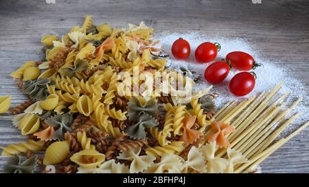 Food, Italian pasta, noodles, ingredients. Cooking. Cherry tomatoes, durum flour. Stock Photo