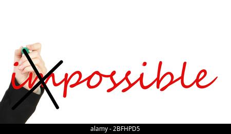 Human hand turning word impossible into possible Stock Photo