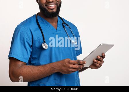 Cropped of african doctor holding digital tablet Stock Photo
