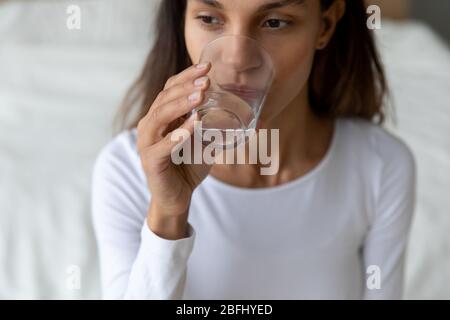 Close up thirsty beautiful girl drinking pure mineral water Stock Photo