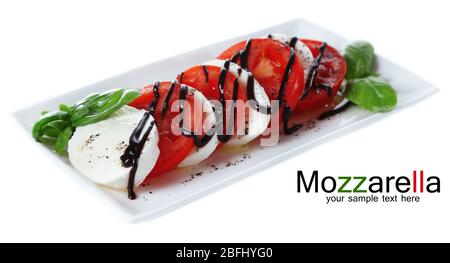Caprese salad on plate, isolated on white Stock Photo