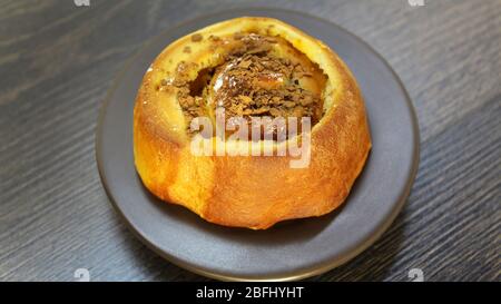 Chocolate bun on a wooden table Stock Photo