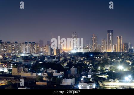 Aerial panorama shot of buildings skyscrapers with offices and residences with lights on at night Stock Photo