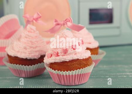 Tasty cup cakes with cream Stock Photo