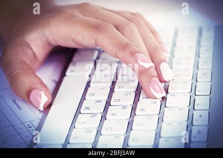 Female hands typing on keyboard, close-up Stock Photo
