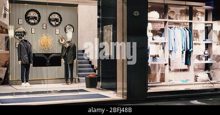 Milan, Italy circa January, 2020: Historical buildings, stores and boutique shops on Via Montenapoleone street in Milan at night, luxury shopping street Stock Photo