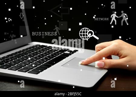 Businesswoman using laptop with digital layer effect on background Stock Photo