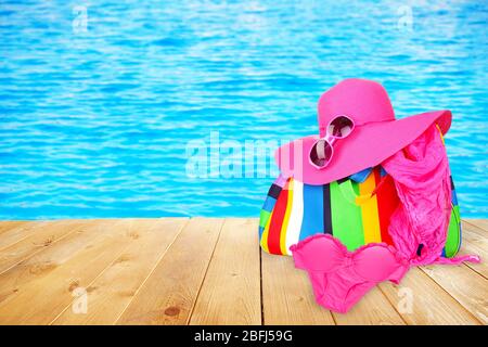 Bright beach accessories on pool background Stock Photo