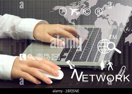 Businesswoman using laptop with digital layer effect on background Stock Photo
