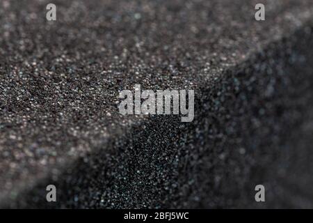 Close-up view of an edge of black rubber foam sponge brick Stock Photo