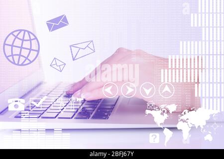 Businesswoman using laptop with digital layer effect on background Stock Photo