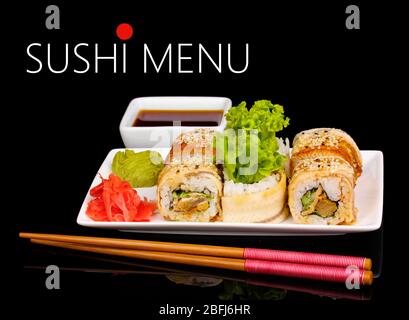 Delicious rolls served on plate isolated on black with space for your text Stock Photo