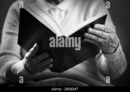 Old woman reading Bible, closeup Stock Photo